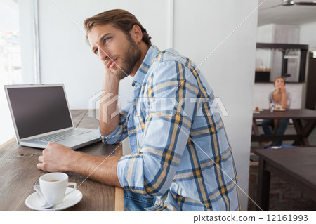 Casual man using laptop having coffee Casual man using laptop having coffee 12161993