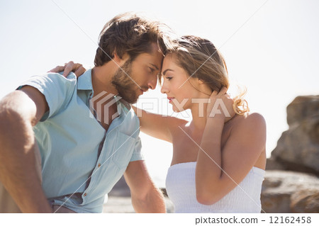 Gorgeous couple embracing at the coast Gorgeous couple embracing at the coast 12162458