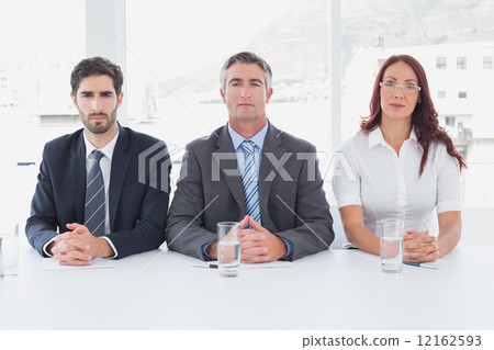 Serious business people sitting together 12162593