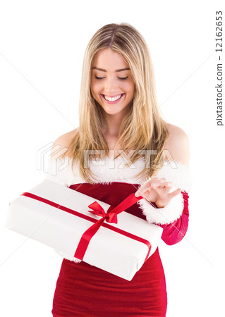 Pretty santa girl opening gift 12162653