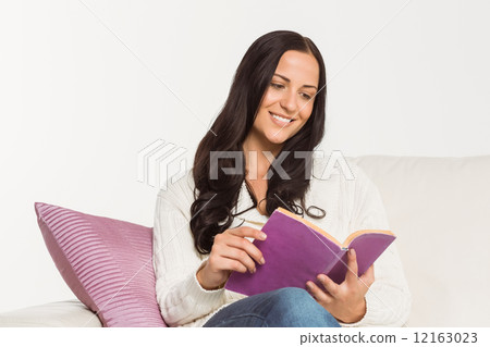 Smiling woman reading a book Smiling woman reading a book 12163023