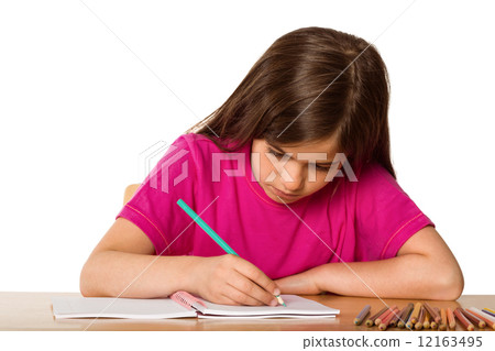 Cute pupil working at her desk 12163495
