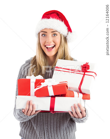 Festive blonde holding pile of gifts 12164006
