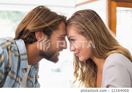 Happy couple touching their heads Happy couple touching their heads 12164008