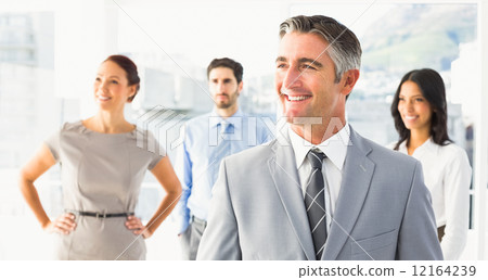 Smiling businessman and his co-workers 12164239