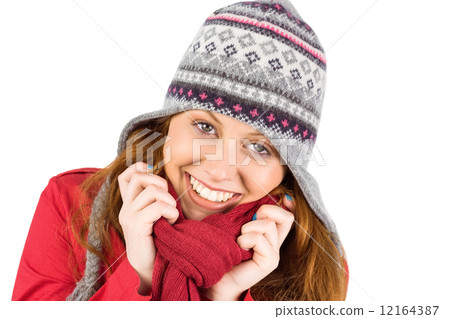 Cold redhead wearing coat and hat 12164387