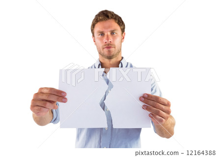 Man holding torn white paper 12164388