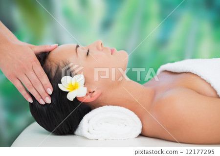 Beautiful brunette enjoying a head massage 12177295