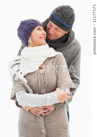 Happy mature couple in winter clothes embracing 12177373