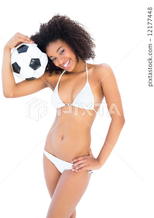 Smiling fit girl in white bikini holding football Smiling fit girl in white bikini holding football 12177448
