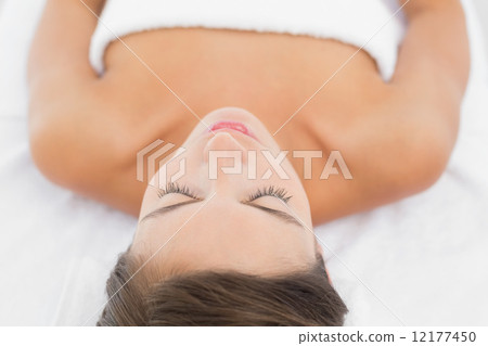 Beautiful woman lying on massage table at spa center Beautiful woman lying on massage table at spa center 12177450