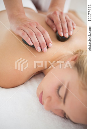 Beautiful blonde enjoying a hot stone massage 12177451