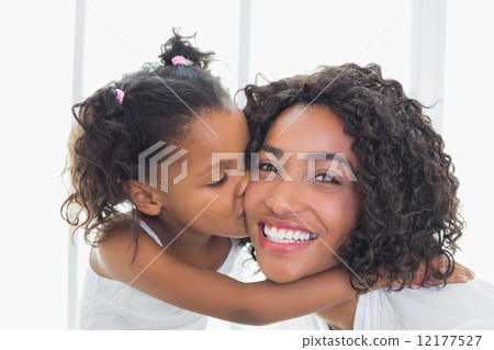 Pretty mother with her daughter kissing her cheek 12177527