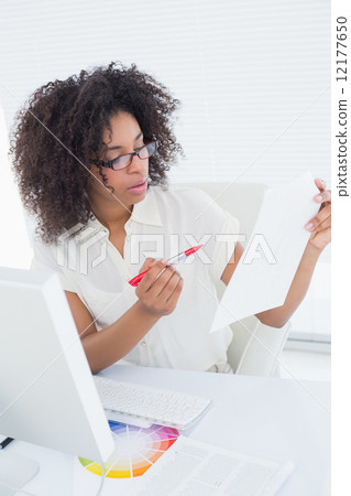 Pretty photo editor working on contact sheet 12177650