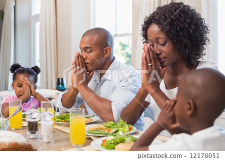 Happy family saying grace before meal Happy family saying grace before meal 12178051