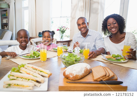 Happy family enjoying a healthy meal together Happy family enjoying a healthy meal together 12178152