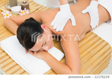Peaceful brunette enjoying an exfoliating back massage 12178229