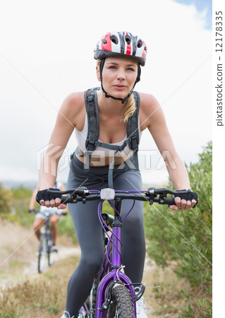 Fit couple cycling on mountain trail 12178335