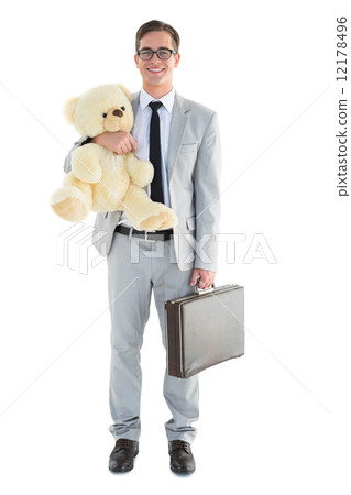 Handsome businessman holding briefcase and teddy 12178496