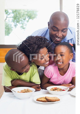Happy family having breakfast together in the morning 12178819