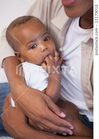 Happy father spending time with baby on the couch Happy father spending time with baby on the couch 12179018