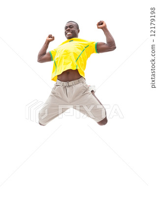 Happy brazilian football fan jumping up 12179198