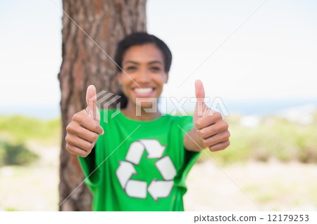 Pretty environmental activist smiling at camera showing thumbs u Pretty environmental activist smiling at camera showing thumbs u 12179253
