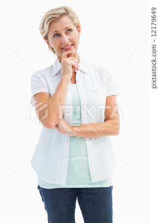 Happy mature blonde thinking with hand on chin Happy mature blonde thinking with hand on chin 12179649