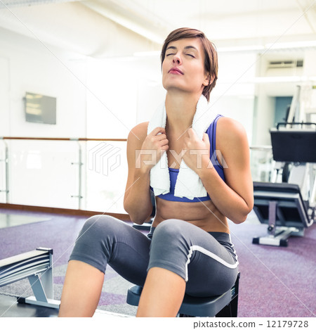 Fit brunette working out on rowing machine Fit brunette working out on rowing machine 12179728