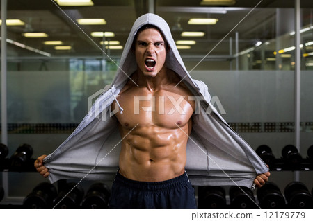 Muscular man shouting in health club 12179779