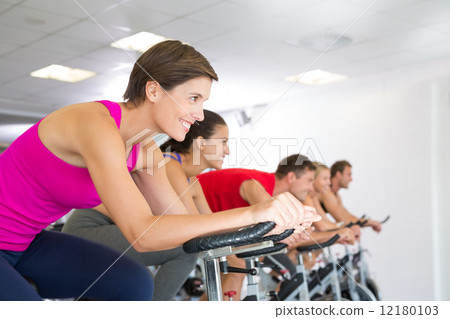 Spin class working out and smiling Spin class working out and smiling 12180103