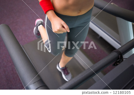 Fit woman running on the treadmill 12180105
