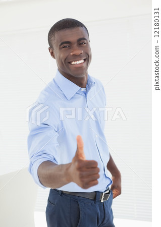 Happy businessman showing thumbs up 12180131