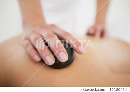Woman enjoying a hot stone massage 12180414