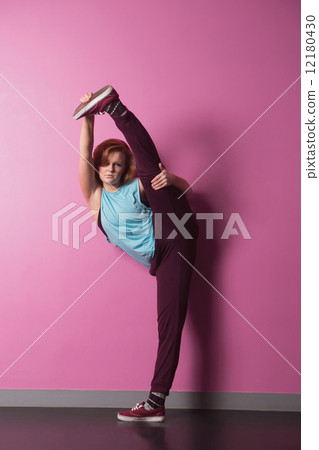 Pretty break dancer lifting her leg above head Pretty break dancer lifting her leg above head 12180430