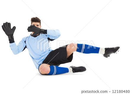 Goalkeeper in blue making a save Goalkeeper in blue making a save 12180480