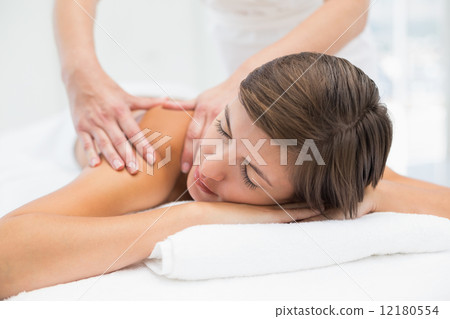 Attractive woman receiving shoulder massage at spa center Attractive woman receiving shoulder massage at spa center 12180554