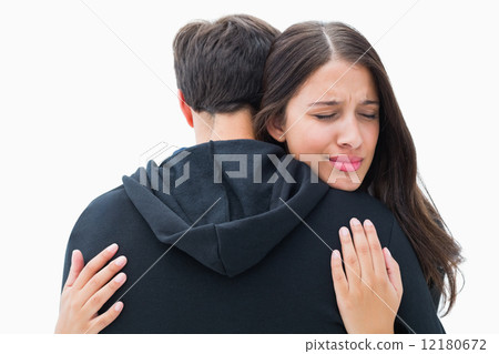 Unhappy brunette hugging her boyfriend Unhappy brunette hugging her boyfriend 12180672