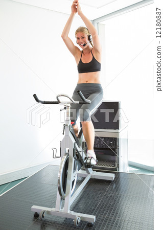 Spin class led by motivational instructor 12180887