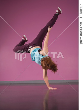 Pretty break dancer doing handstand with one hand 12180903