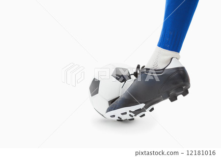 Football player in blue controlling the ball Football player in blue controlling the ball 12181016