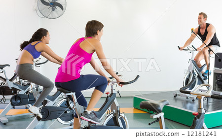 Spin class working out with motivational instructor 12181241