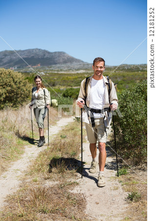 Happy hiking couple walking on country trail Happy hiking couple walking on country trail 12181252