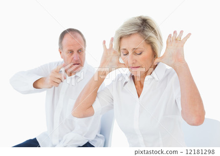Older couple sitting in chairs arguing 12181298