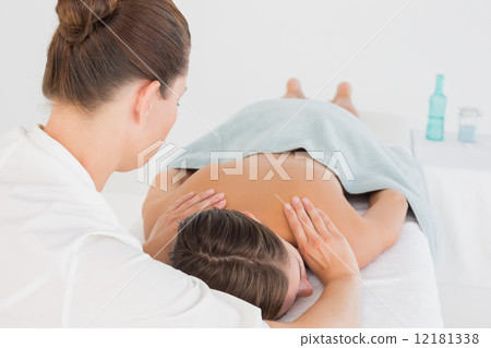 Attractive young woman receiving shoulder massage 12181338