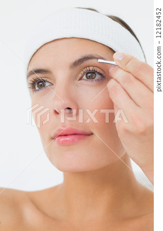 Hand applying eyeshadow to beautiful woman Hand applying eyeshadow to beautiful woman 12182452