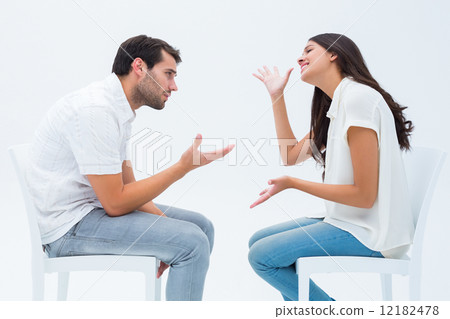 Couple sitting on chairs arguing 12182478