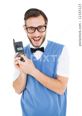 Geeky hipster holding a retro cellphone 12183123