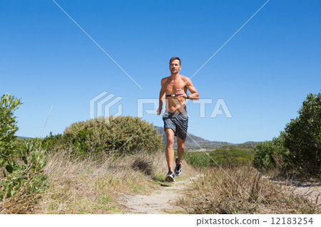 Shirtless man jogging with heart rate monitor around chest Shirtless man jogging with heart rate monitor around chest 12183254
