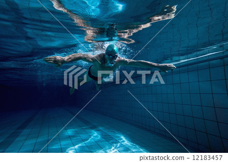 Fit swimmer training by himself Fit swimmer training by himself 12183457